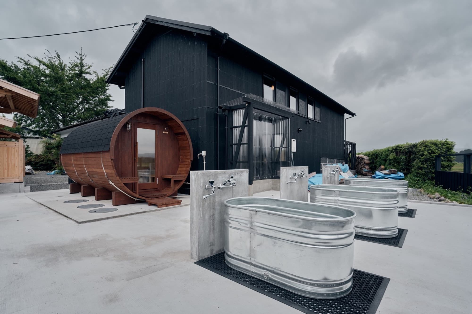 Barrel sauna and cold plunge tubs on the terrace